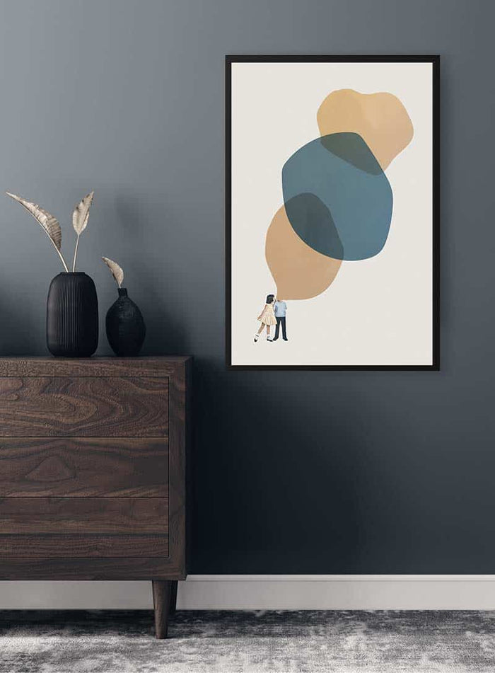 Framed "A thousand stories to tell you" art print by Maarten Léon hanging above a wooden dresser.