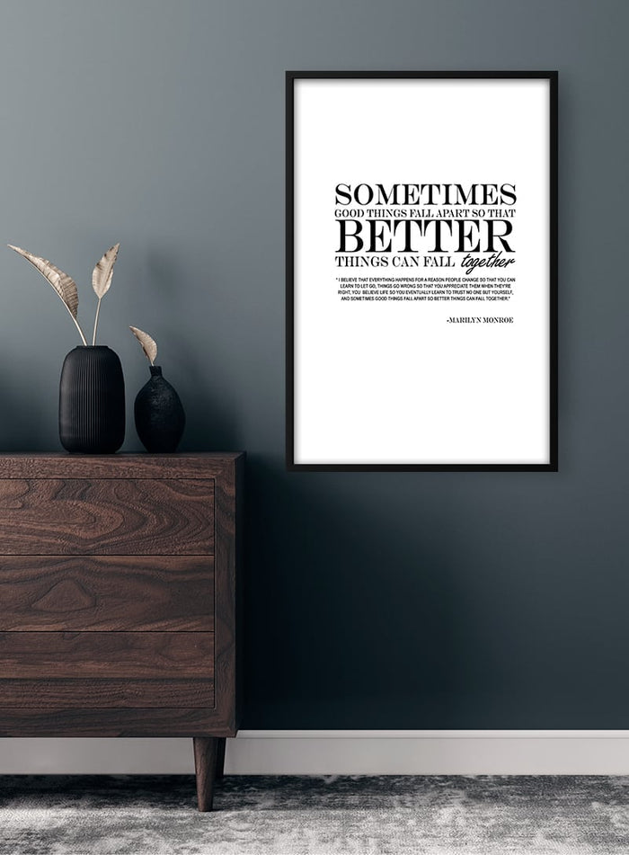 Framed "Better Things" inspirational quote poster on a dark wall above a wooden dresser with vases.