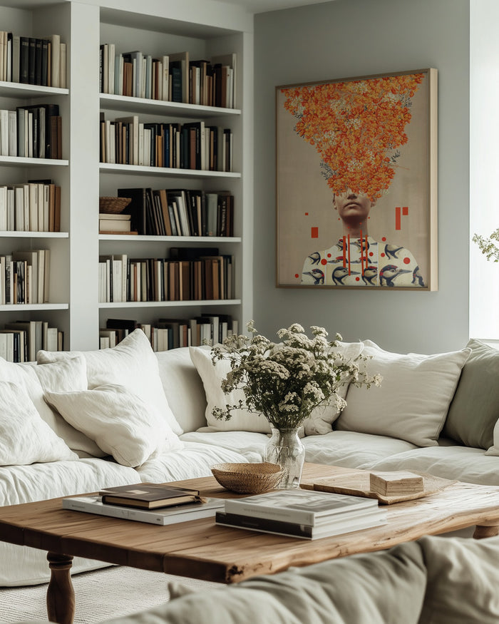 Framed Bird Flight In Autumn by Frank Moth hanging above a light sofa in a cozy, book-filled living room.