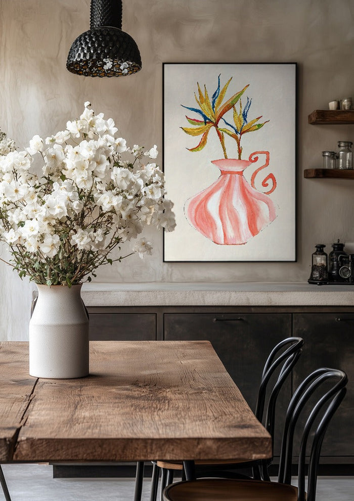 Bird of paradise by Marjorie Salvagni in a black frame above a rustic table with white flowers