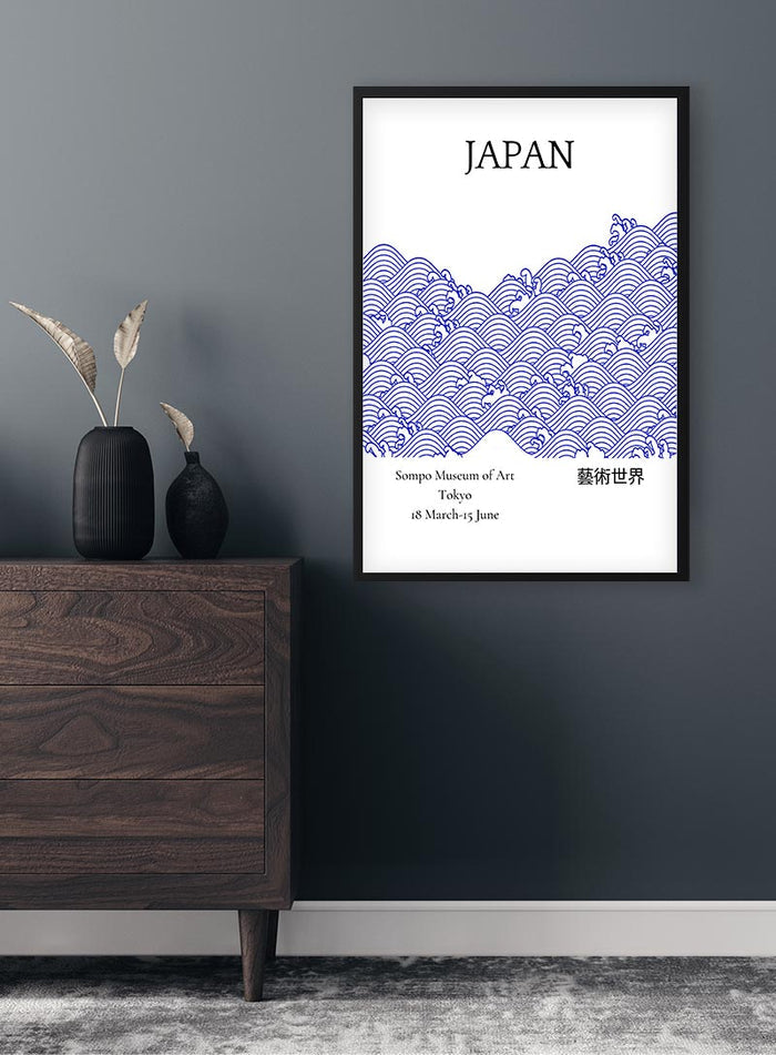 Blue from Japan Exhibition Plakat featuring traditional Japanese wave pattern in blue on a white background, framed on wall.