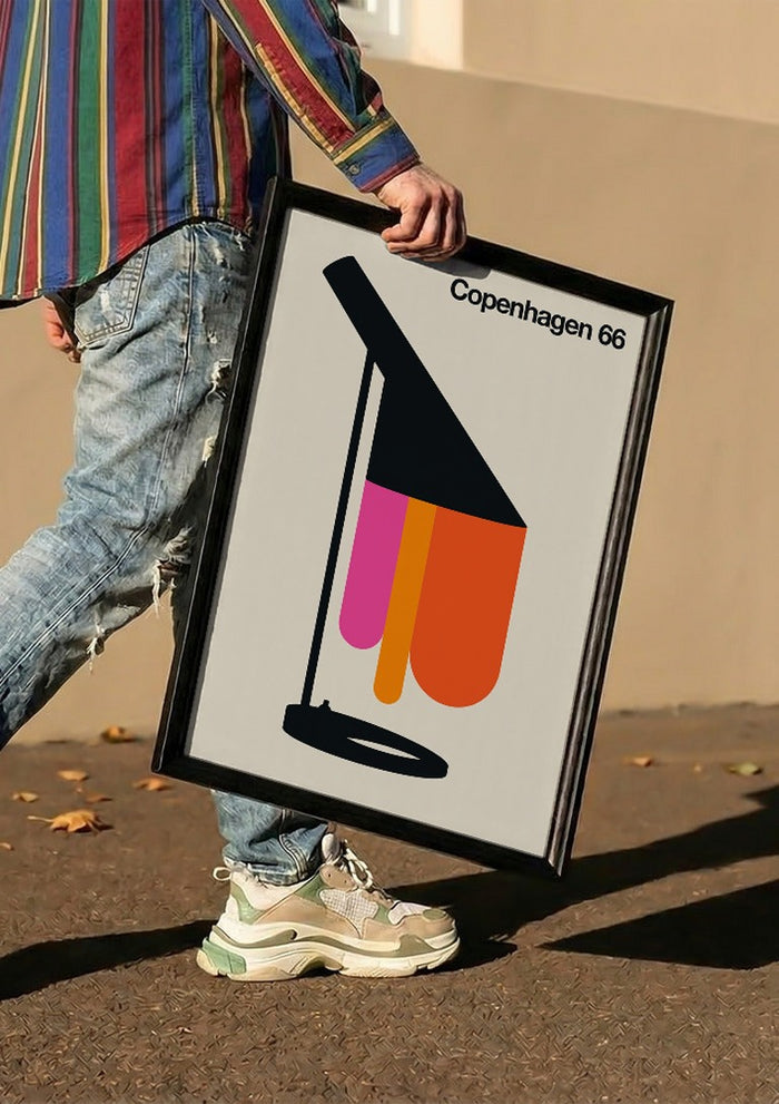Copenhagen 66 by Bo Lundberg carried in a black frame along a sunny street