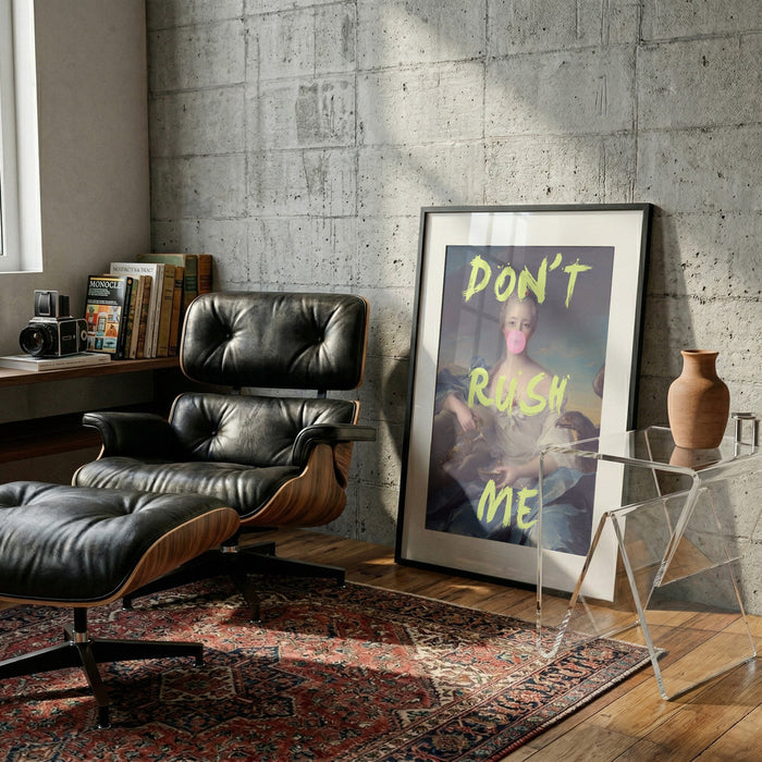Framed "Don't Rush Me Portrait" by Talitha McQueen leaning against a wall in a modern living room.