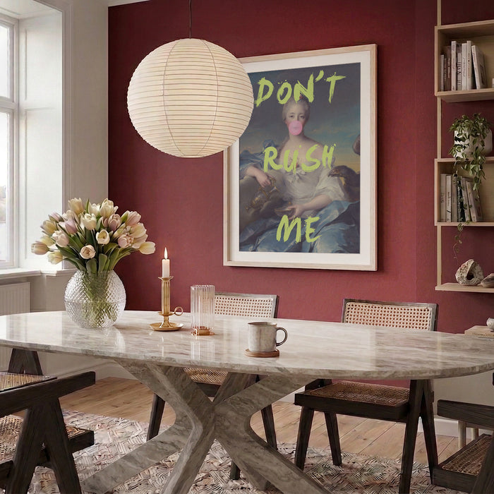 Don't Rush Me Portrait by Talitha McQueen hanging on a red wall in a modern dining room.