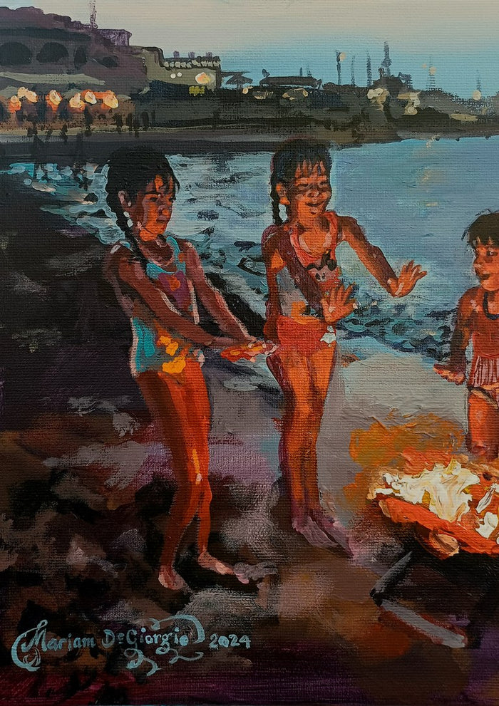 Dusk Delights by Mariam De Giorgio — three children in swimsuits lit by an orange beach fire on a rocky shore at dusk.