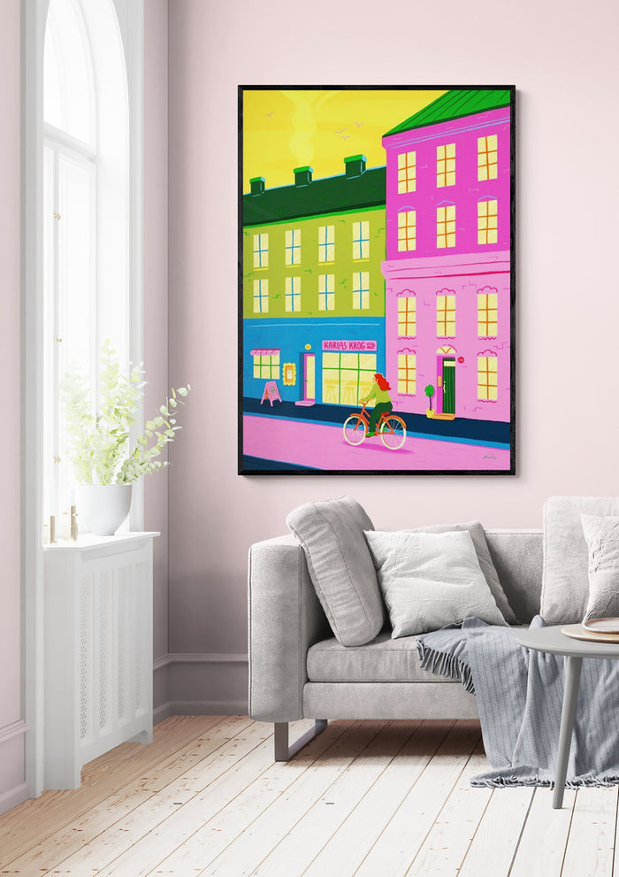 Colorful cityscape artwork "Home Through The City" by Nanna Paavig displayed above a modern living room sofa.