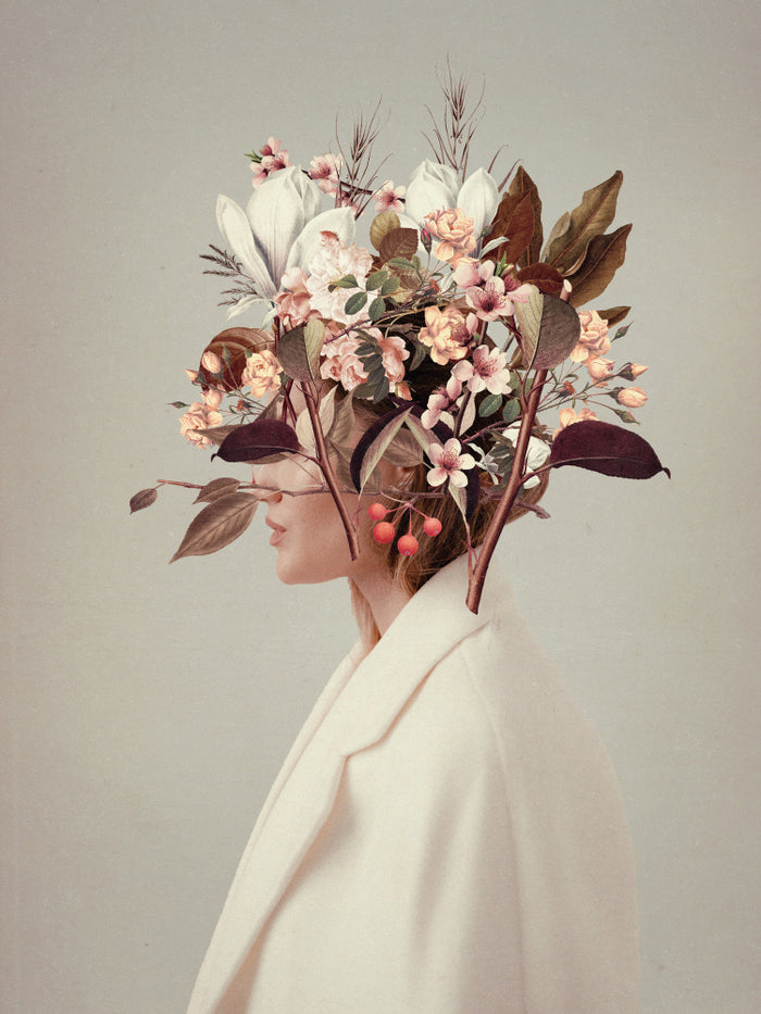 Surreal portrait of a woman in white coat with autumn flowers and leaves blooming from her head.