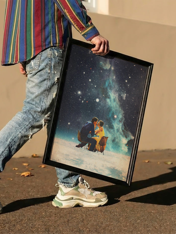 Person holding "I'll Take You To the Stars for a Second Date" artwork by Frank Moth, featuring a cosmic scene.