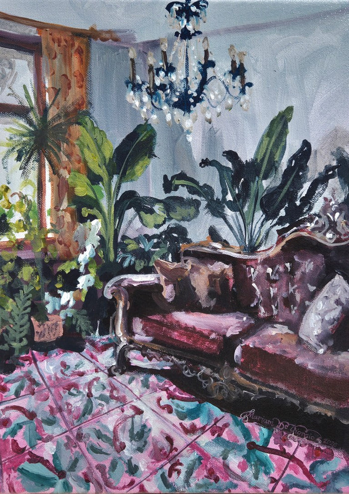 Living room with Maltese tiles by Mariam De Giorgio — a burgundy carved sofa and green plants above a pink and teal patterned tile floor