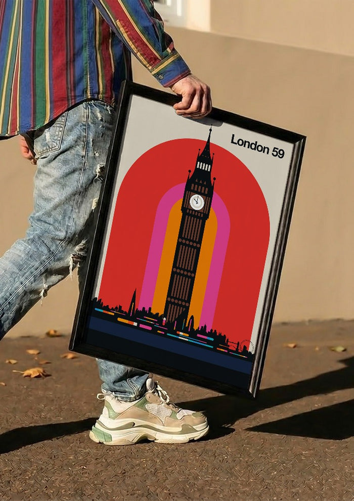 London 59 by Bo Lundberg carried in a black frame along a sunny street