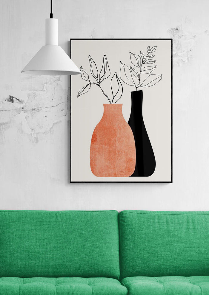 Framed "Madame a Monsieur" artwork by Boris Draschoff above a green sofa and under a white pendant lamp.