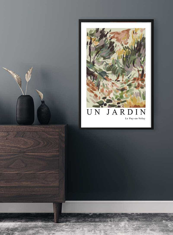 Framed Matisse Inspired Un Jardin Plakat with abstract garden artwork hanging on a dark gray wall above a dresser.