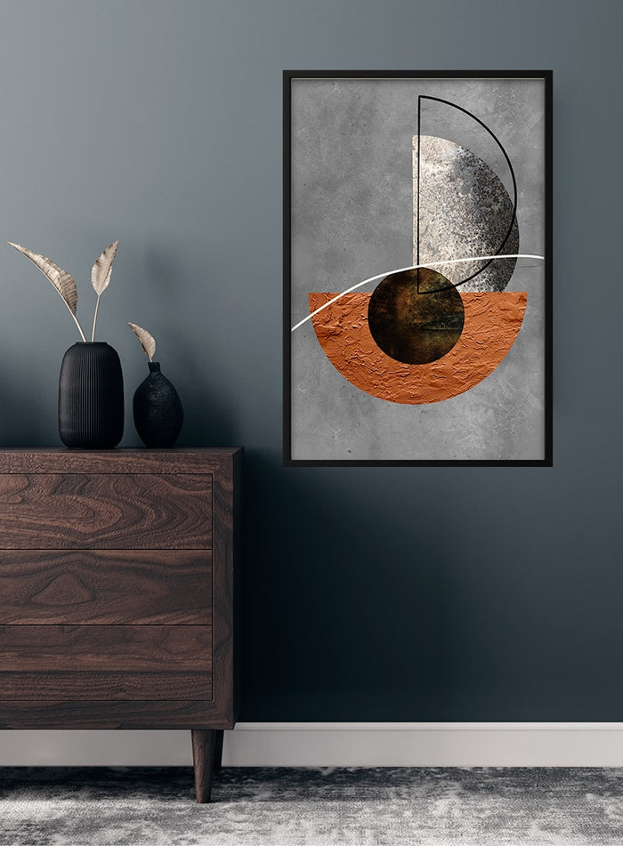 Minimalistic brown and silver abstract poster hanging on a dark wall above a wooden dresser with decor.