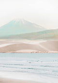 Minimalist print of a serene beach with gentle waves and a misty mountain in the background.
