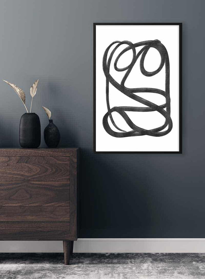 Framed Mysterious Sketch Plakat with black abstract lines, displayed above a dark wooden dresser in a modern room.
