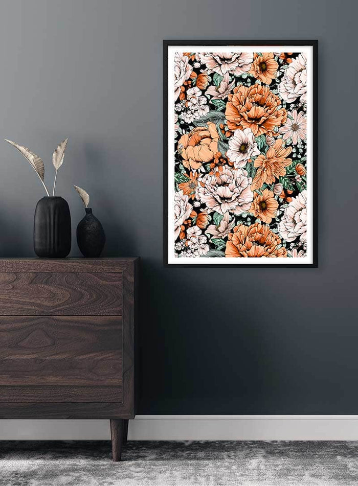 Framed Orange Flowers No. 1 Plakat featuring vibrant orange and white floral pattern on a dark wall.