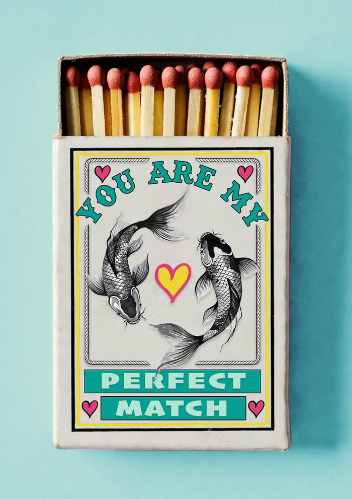 Perfect Match by Daniel Leo — vintage matchbox poster with two engraved koi carp circling a yellow heart