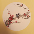 Plum Blossom Pair by Tracey - two small birds on a red plum blossom branch in a white circle on yellow