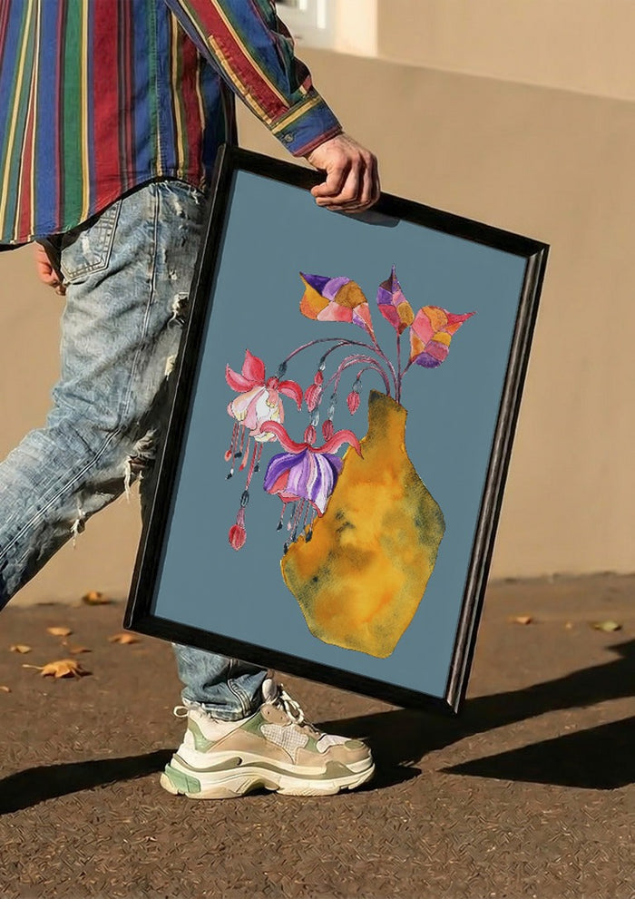 Princess earring by Marjorie Salvagni carried in a black frame along a sunny street