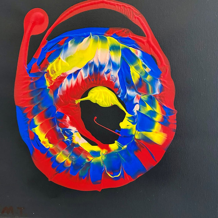 Spin by Maria-Tia - swirled ring of red, blue and yellow paint on black
