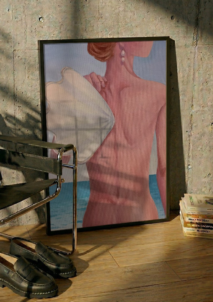 The wing by NeReid in a black frame leaning against a concrete wall by a steel chair