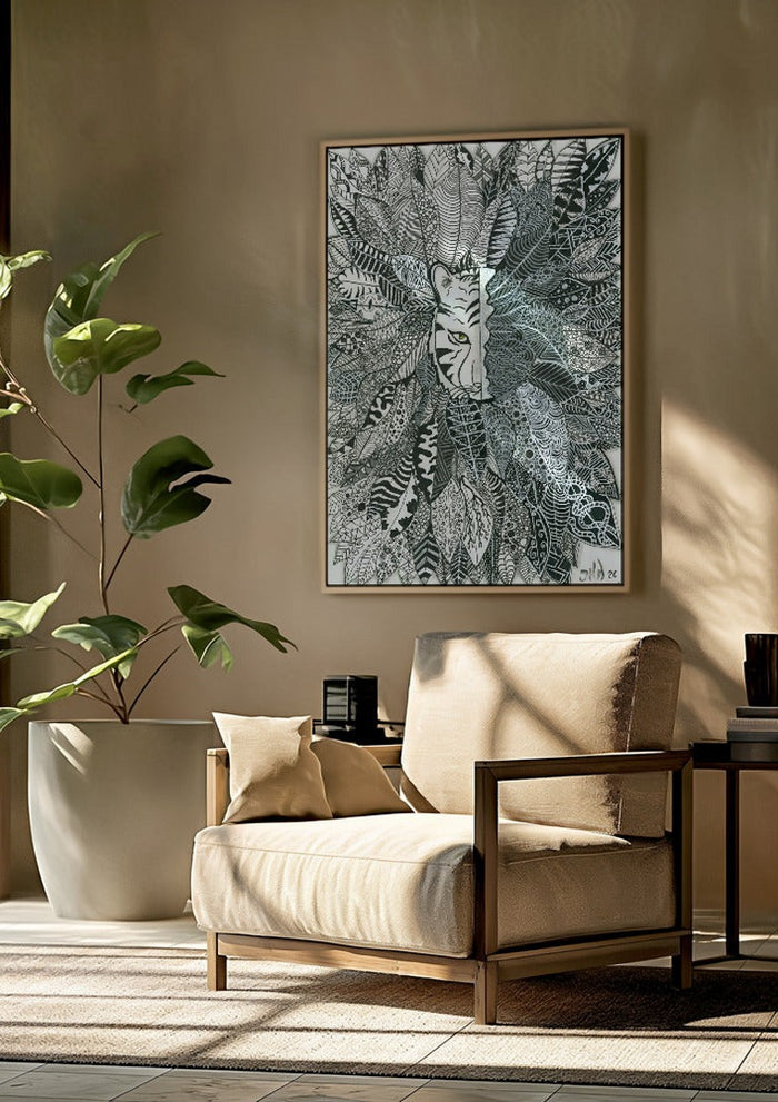 Tiger in the Leaves by JHN.ByHjort framed above a beige armchair beside a potted plant