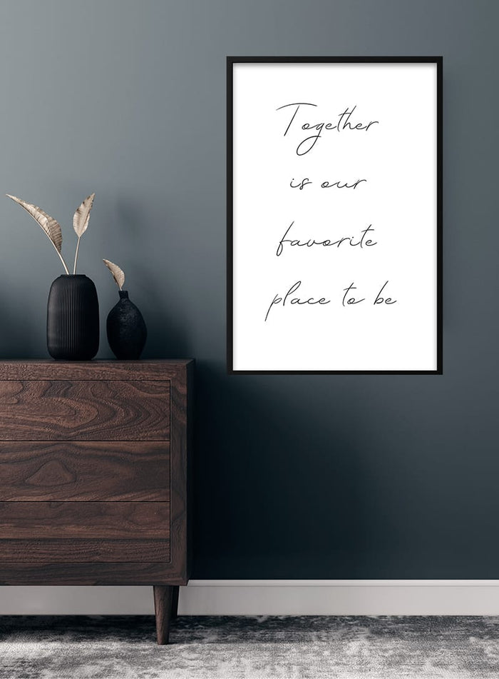 "Together is our favorite place to be" poster displayed above a wooden dresser in a modern room.