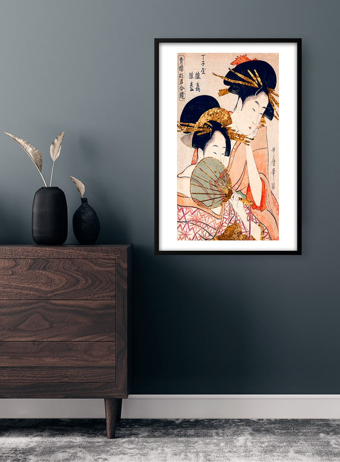 Framed poster of traditional Japanese women in kimonos displayed on a dark wall above a wooden dresser.
