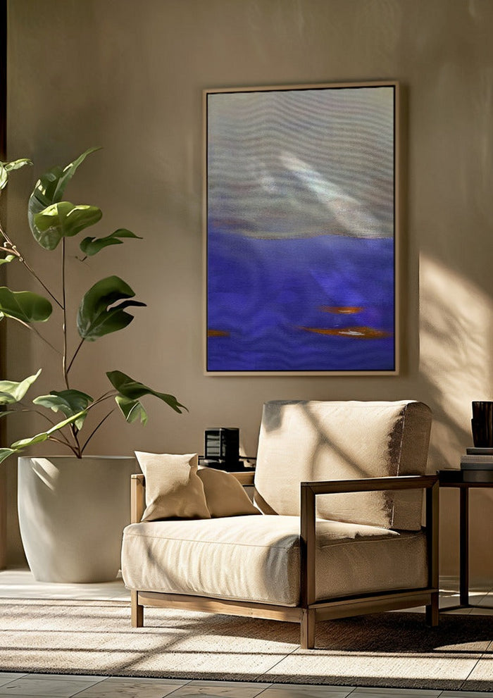 Violet Sea by Marina Agre framed above a beige armchair beside a potted plant