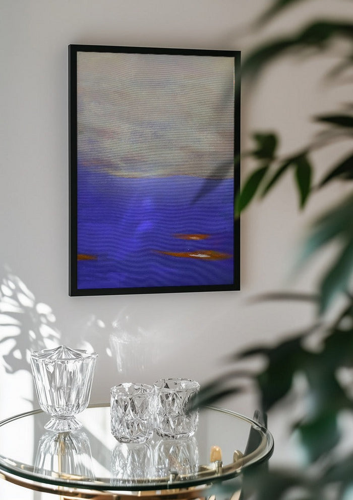 Violet Sea by Marina Agre in a black frame above a glass table with crystal glassware