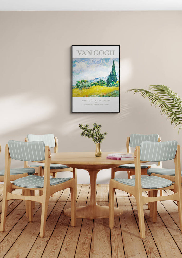 Framed Van Gogh "Wheat Field" art print displayed above a wooden dining table with four chairs.