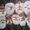 Winter Masks by Cristina Iacob - ten bearded carnival masks in red, green and ochre against a dark ground