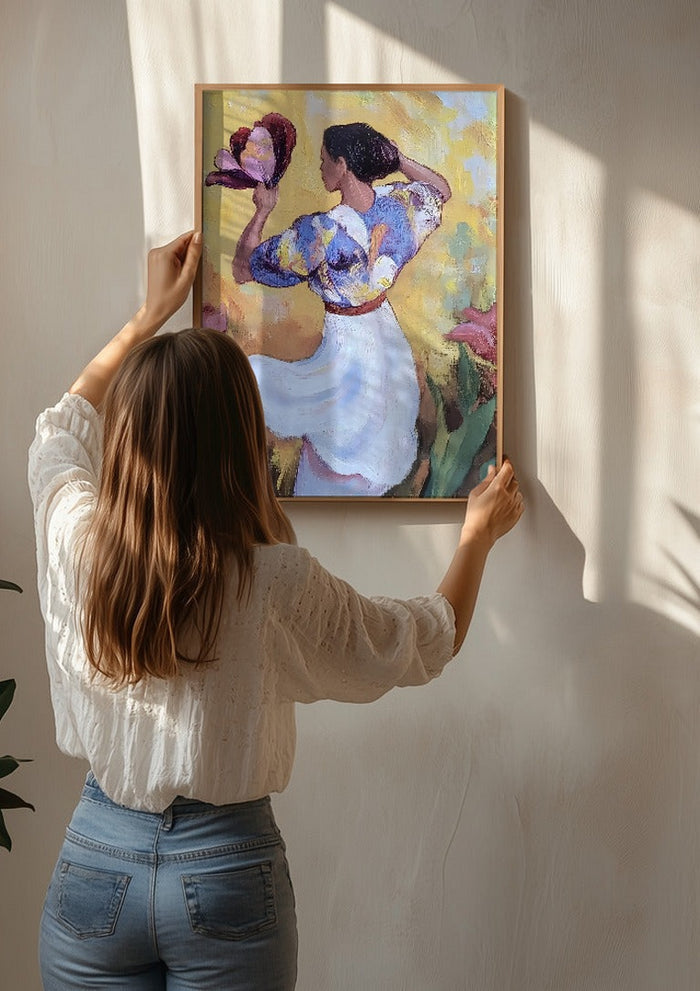 Woman with a Tulip by Elena Avanesova being hung on a sunlit wall