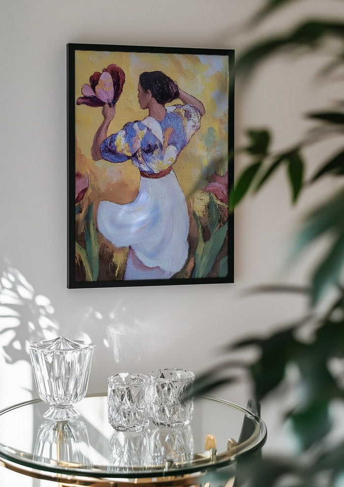 Woman with a Tulip by Elena Avanesova in a black frame above a glass table with crystal glassware