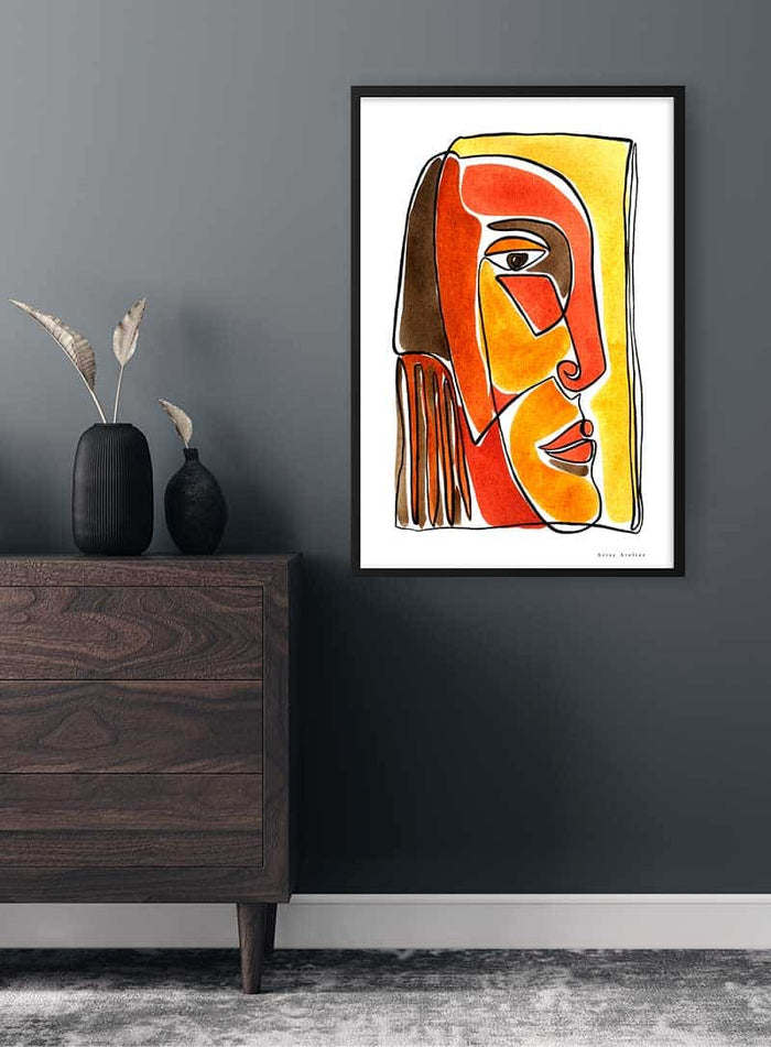 Framed Yellow and Red Face Imaginaires Plakat artwork displayed on a dark wall above a wooden dresser.