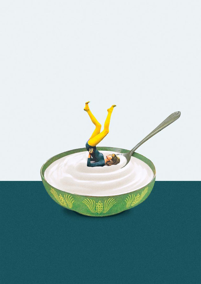 A miniature figure does a yoga pose in a bowl of yogurt with a spoon, promoting Yoga in my yogurt by Maarten Léon.
