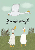 Pastel illustration of a crowned white swan flying above two ducks on a green hill, with the words You are enough.
